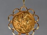 une image représentant un pendentif en or avec le visage d'une femme au centre