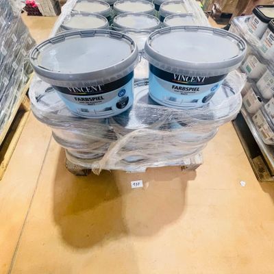 three buckets of paint sitting on a pallet in a store