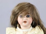 a close up of a doll with long hair