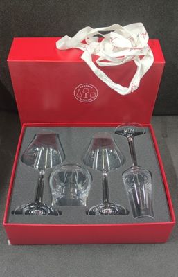 four wine glasses in a red box with a white ribbon