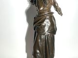 bronze statue of a woman holding a cigarette on a white background