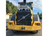 the back end of a large yellow truck parked in a parking lot