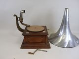 a small metal object next to a small metal object on a white surface