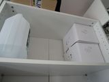 a refrigerator and a freezer in a small room