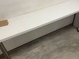 un banc blanc qui se trouve dans un coin de la pièce