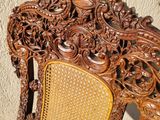 a wooden chair with a wicker back and a yellow seat