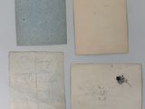 four pieces of old paper with writing on them on a white surface