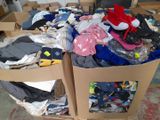 boxes of clothing are stacked on top of each other in a room