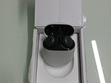 a white box with a pair of black earphones in it