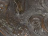 a close up of a bronze statue of a woman
