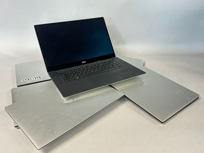 three laptops sitting on top of each other on a table