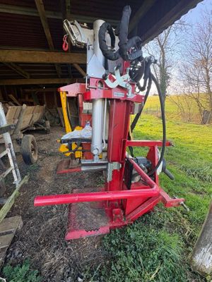 a red machine that is sitting in the grass