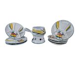 three pieces of white and yellow dinnerware on a white table