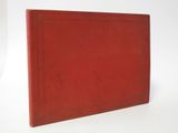 a red book sitting on top of a white surface