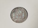 a close up of a coin on a white surface