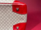 an image of a white and red handbag on a pink background