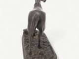 bronze statue of a horse standing on a base on a white background