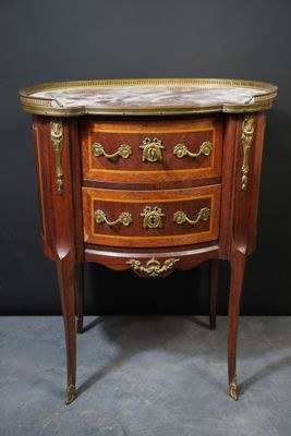 an antique wooden chest of drawers with a marble top