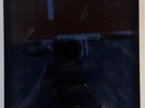 tablet computer sitting on top of a table next to a person ' s hand