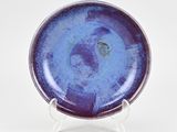 purple and blue plate on stand on white background