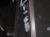 a black car with a broken door and a broken window