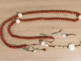 a beaded necklace and bracelet set on a wooden table