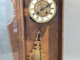 a clock that is sitting inside of a glass case