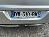 a silver car that has a license plate on it