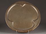 an image of a brown plate sitting on top of a metal stand