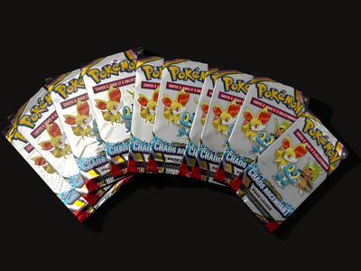 several packs of pokemon cards are stacked on top of each other