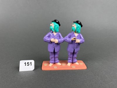 two figurines of two men dressed in purple suits and black hats