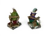 two figurines of a man and a woman sitting on a bench