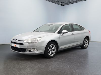 the silver car is parked in the empty room of the building