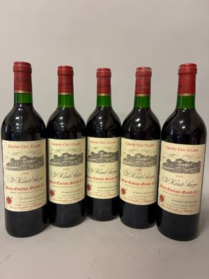 four bottles of wine are lined up on a table