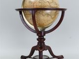 an antique globe on a stand with a wooden base