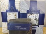 four different types of bedding are displayed on a wooden table