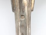 a close up of a metal object on a white surface