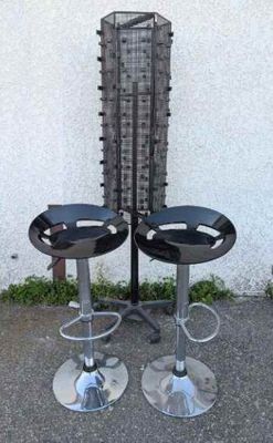 two stools that are sitting in front of a building