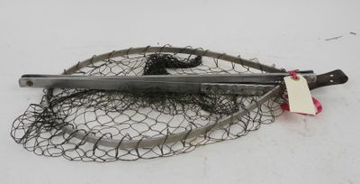 a fishing net and a pair of scissors on the ground