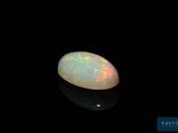 a white oplite in the dark with a black background