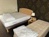 two beds in this small room with no sheets on them