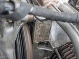 a close up of a motorcycle engine with a number plate on it