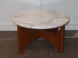 a marble top table with a wooden base in a room