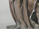 a statue of a woman and a dog on a table