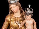 a statue of a woman holding a child on her lap