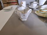 a table with cups and saucers sitting on it