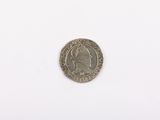 a close up of a coin on a white surface with a white background