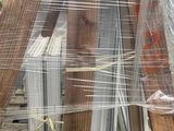a pallet with a bunch of wooden items wrapped in plastic