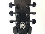 a guitar head with a picture of a man on it