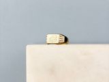 a picture of a gold signet ring on a marble block